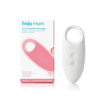 Package of the Frida Mom Lactation Massager placed next to a white massager standing up. Package says, 2 in 1 lactation massager, vibration plus heat to bust through buildup and get milk flowing.